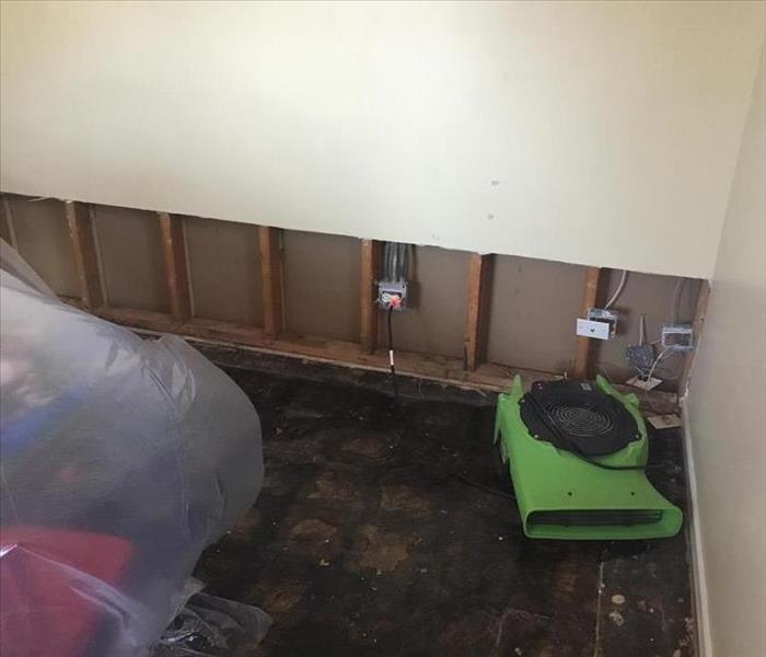 Photo of a flood cut, a horizontal cut in a wall, to remove water damaged drywall