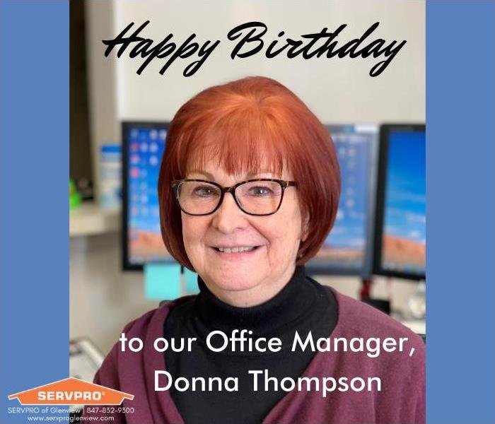 birthday wishes to a 70 year old woman named Donna with red hair and glasses as she sits in front of her computer